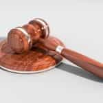 A courtroom gavel against a white background.