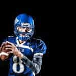 A male American football player in a blue outfit.