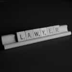 Scrabble letters spell out the word LAWYER.