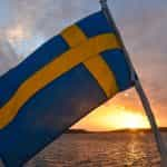 A blue and yellow flag on a boat in the water